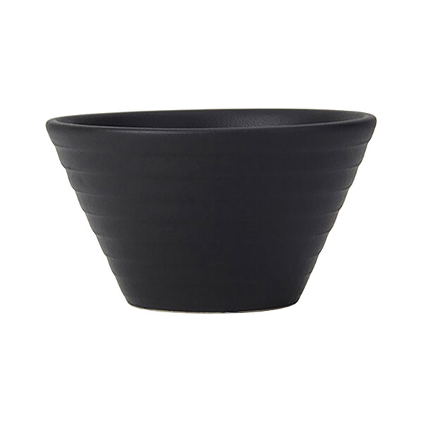 A matte black Tuxton china bouillon bowl with embossed curved details.