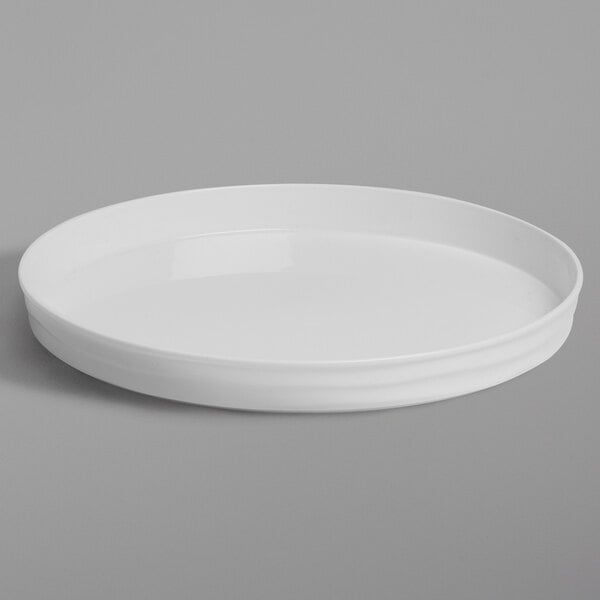 An American Metalcraft white plastic round serving tray with a rim on a gray background.