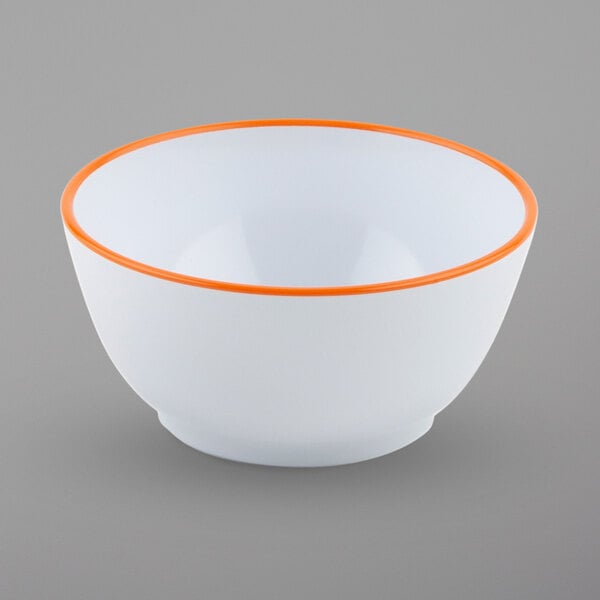 A close up of a GET white melamine bowl with a tangerine orange rim.