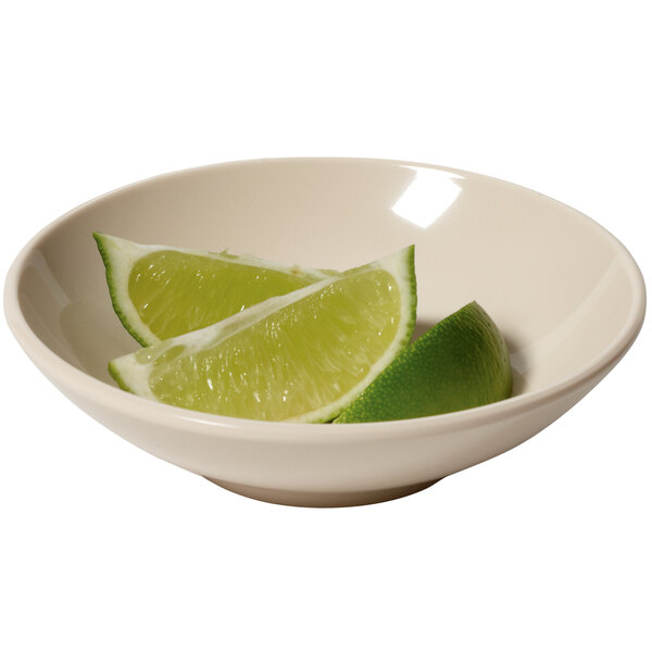 A GET Manila melamine bowl with a lime wedge.