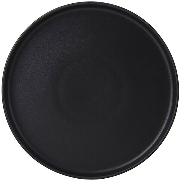 A black round Tuxton china plate with a circular pattern on the surface.