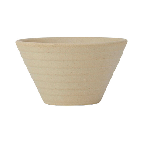 A Tuxton TuxTrendz Zion matte beige china bouillon cup with an embossed surface.