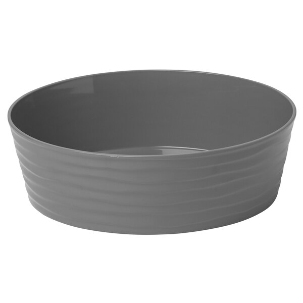 An American Metalcraft Del Mar stackable serving bowl in gray plastic with wavy lines on the rim.