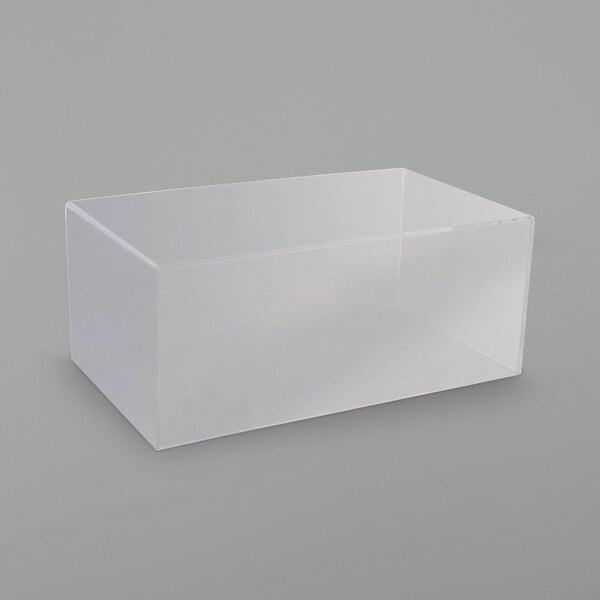 A clear plastic box on a gray surface.