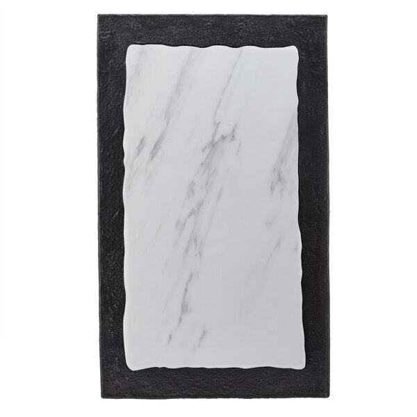 A rectangular white marble serving platter with black lines.