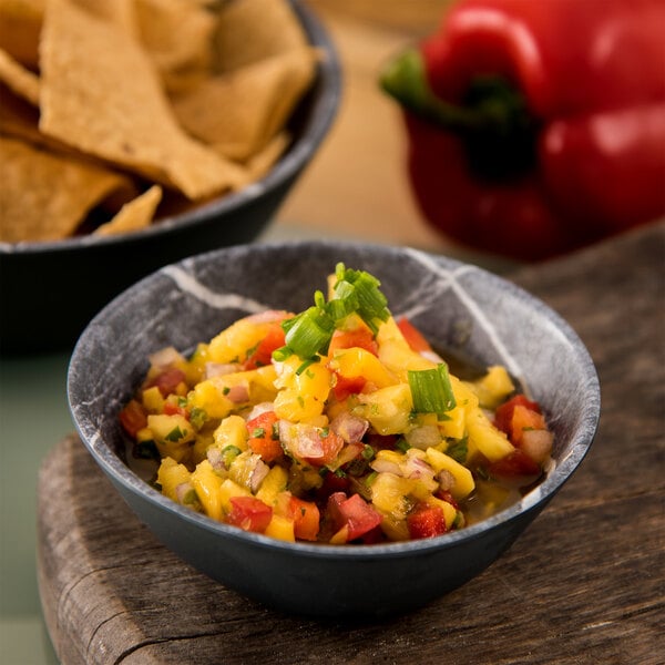 A Carlisle Soapstone Melamine bowl of salsa with tortilla chips.