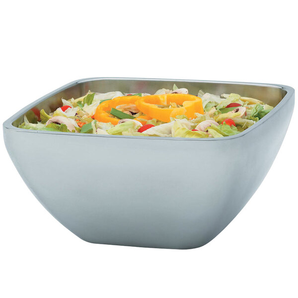 A Vollrath metal serving bowl filled with salad with peppers, onions, and lettuce.