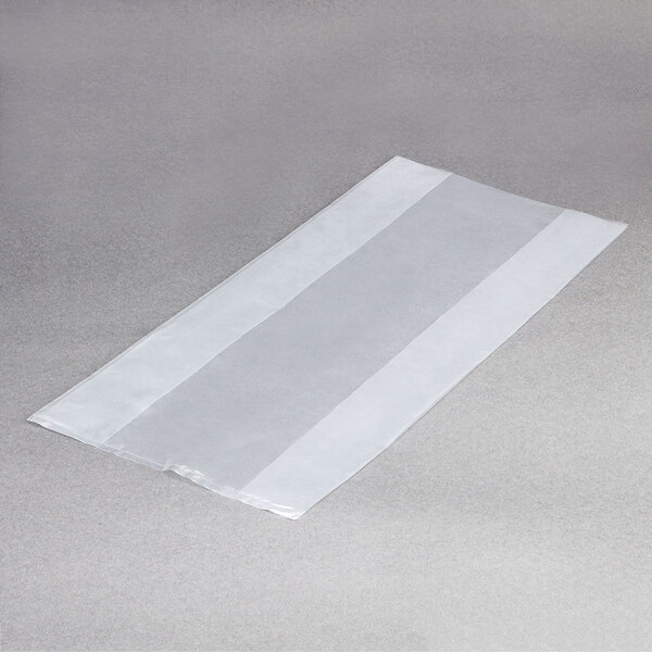 A white plastic LK Packaging food bag on a grey surface.