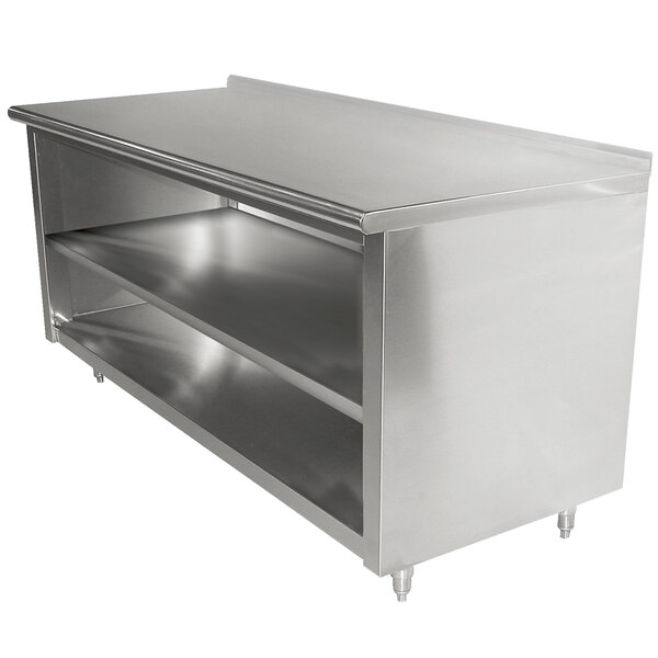 A stainless steel Advance Tabco work table with shelves on a counter.