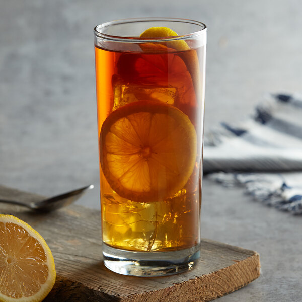 An Anchor Hocking iced tea glass filled with tea, ice, and lemon slices.