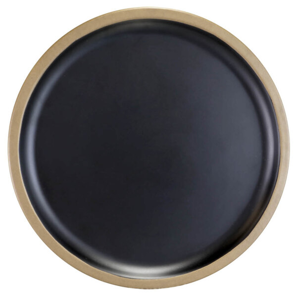 A black melamine lid with a gold rim on a table.