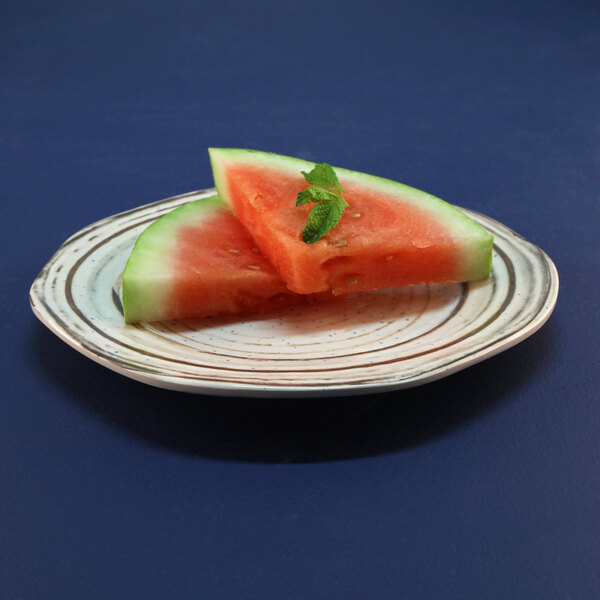 An Elite Global Solutions Doheny melamine plate with a watermelon slice on it.