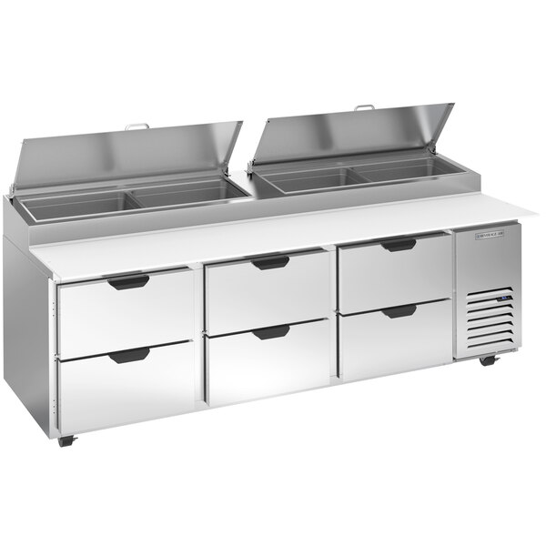 A Beverage-Air stainless steel pizza prep table with six drawers.