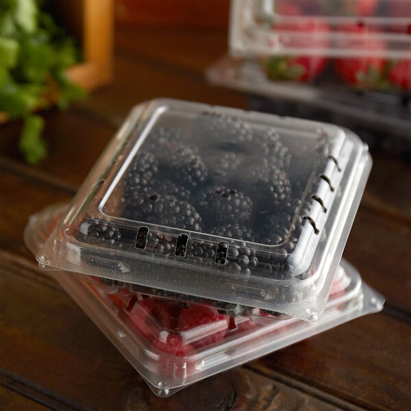Two 6 oz. clear plastic containers of blackberries.