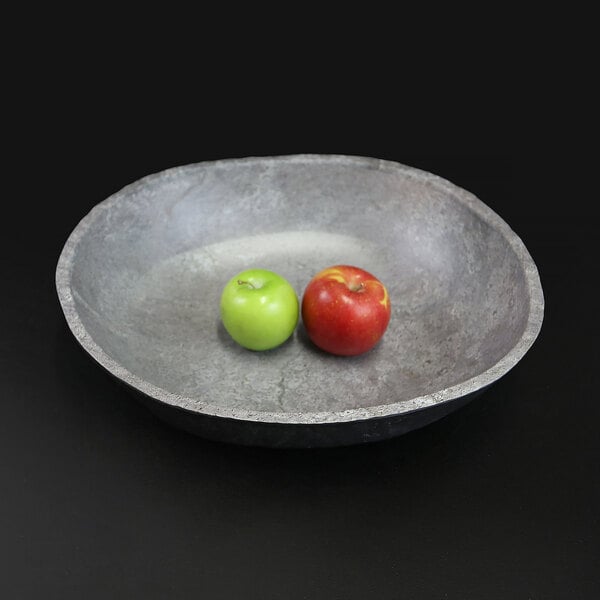An Elite Global Solutions Basalt melamine serving bowl with a green apple and a red apple in it.