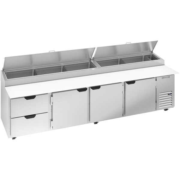 A stainless steel Beverage-Air pizza prep table with three drawers on a counter.