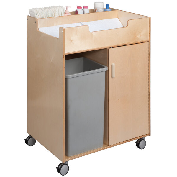 A Whitney Brothers wooden baby changing cabinet with easy access.