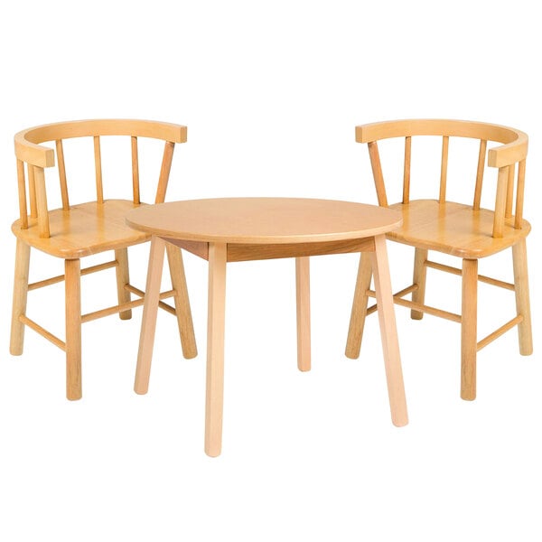 A Whitney Brothers wooden round children's table with two wooden chairs.