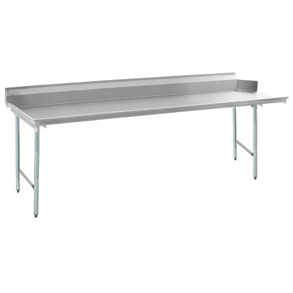 A long stainless steel dish table with a metal surface and legs.