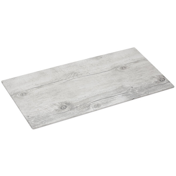 A rectangular white wood melamine display board with a wood grain finish.