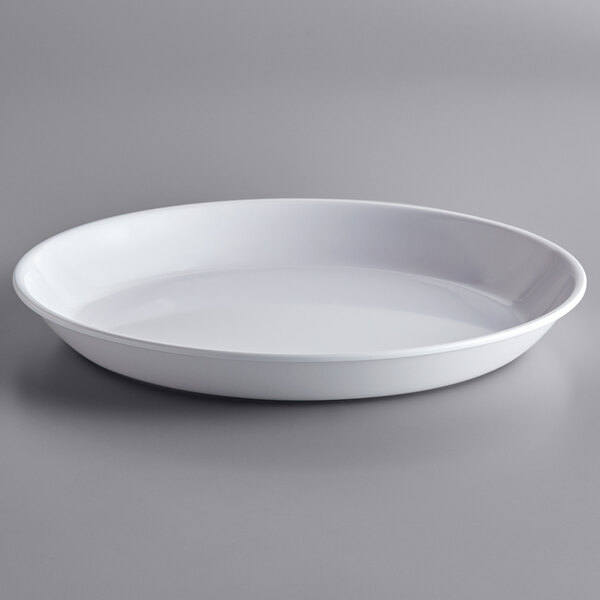A white round bowl insert with a rim on a white surface.