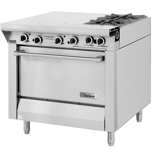 A stainless steel Garland commercial gas range with four burners.