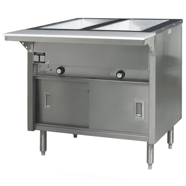 A stainless steel Eagle Group hot food table with sliding doors on a counter in a large commercial kitchen.