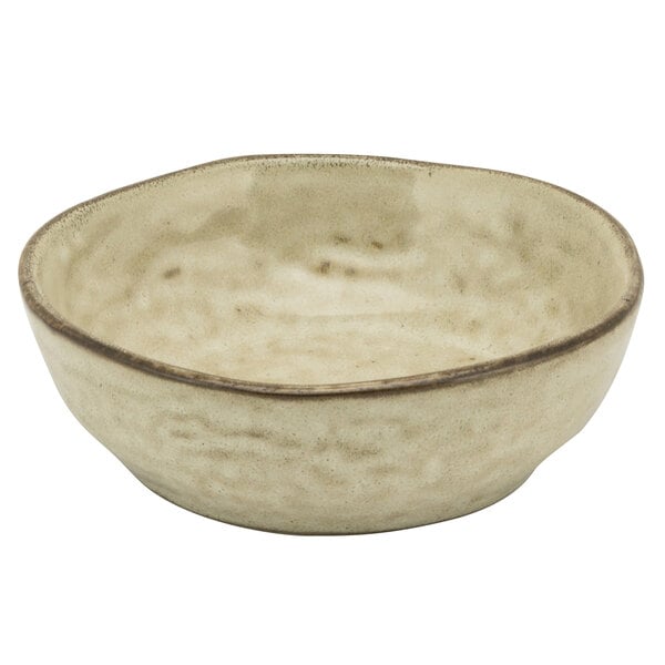 A 10 Strawberry Street beige porcelain coupe bowl with a white rim.
