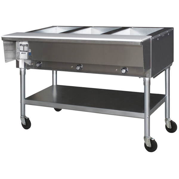 A Eagle Group hot food table with three large stainless steel food containers.