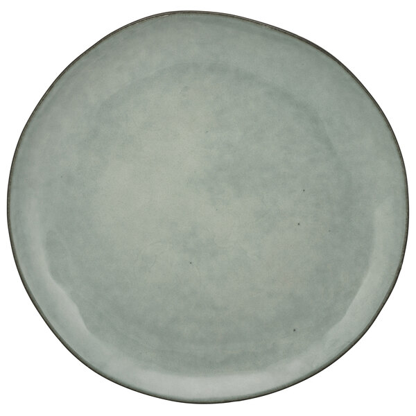 A close-up of a 10 Strawberry Street Firenza blue porcelain coupe plate with a white background.