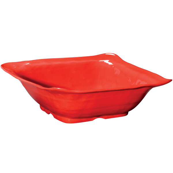 A red square bowl with a handle.