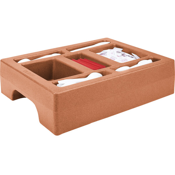 A brown plastic tray with two compartments holding condiments in a Cambro condiment holder.