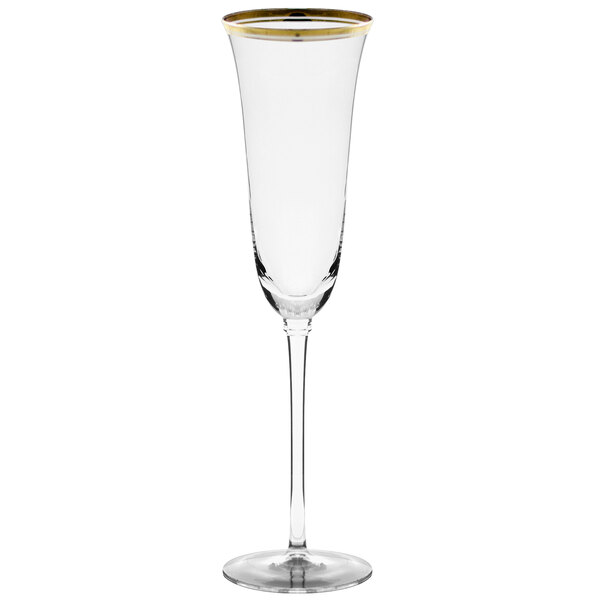 A clear wine glass with a stem and gold rim.