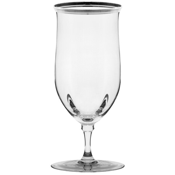 A close-up of a clear 10 Strawberry Street wine glass with a silver rim.