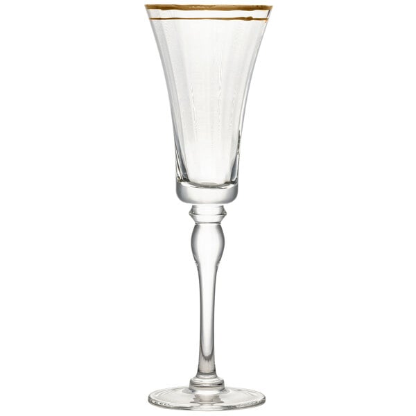 A clear glass champagne flute with a gold rim.