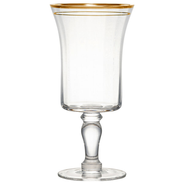 A clear glass wine goblet with a gold rim and stem.