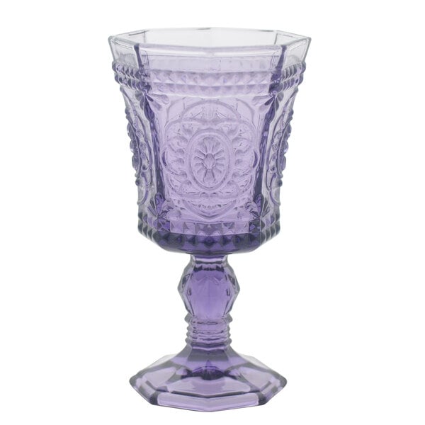 A 10 Strawberry Street Vatican amethyst red wine glass with an ornate design on it.