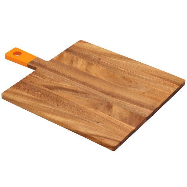 A Fox Run acacia wood square serving board with an orange handle.