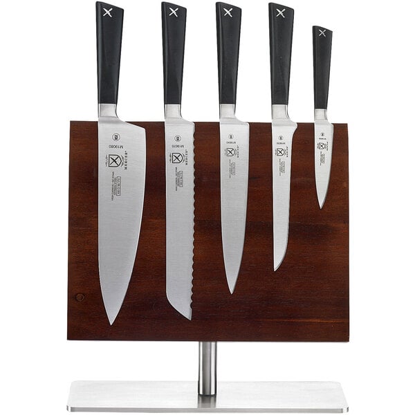 A group of Mercer Culinary knives on a wooden block.
