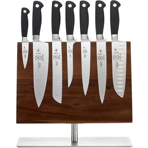 Mercer Culinary Genesis 8-piece knife set on a wooden board.