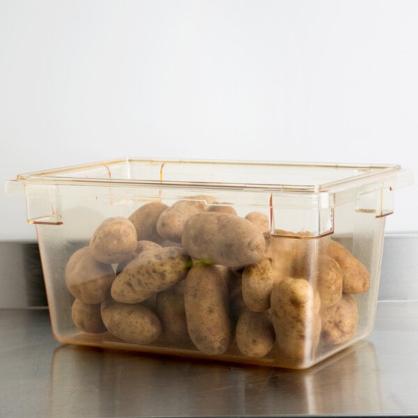 A plastic Cambro food storage container filled with potatoes.