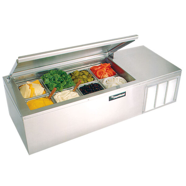A Delfield countertop refrigerated prep rail with containers of lettuce, tomatoes, and various other food items.