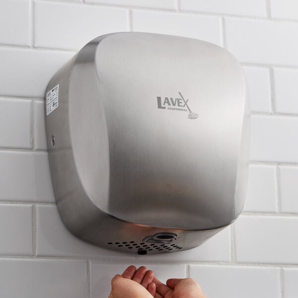 A Lavex stainless steel automatic hand dryer on a white tile wall.