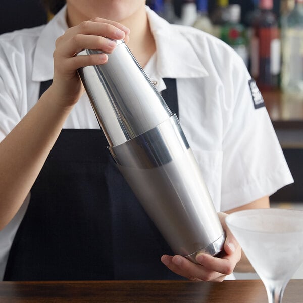 A woman using a Barfly stainless steel Boston cocktail shaker.