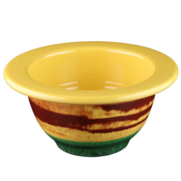 A yellow bowl with a yellow rim and green handle.