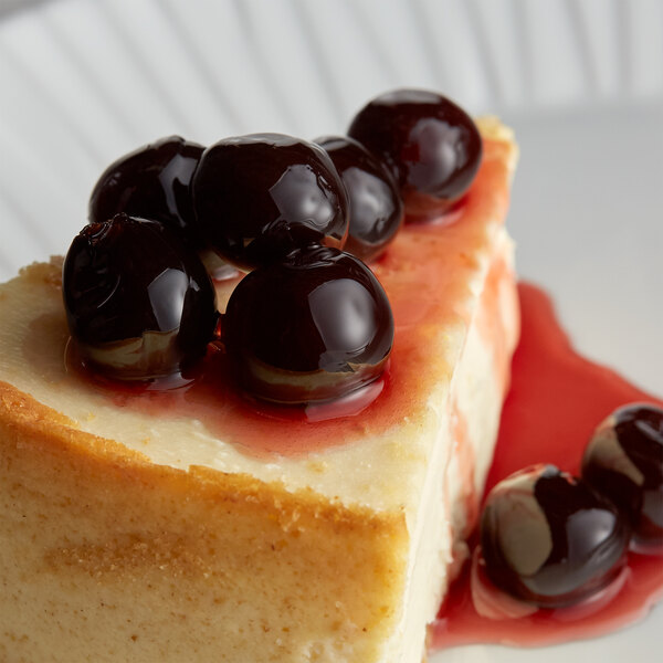 A piece of cheesecake with Fabbri Amarena Cherries on top.