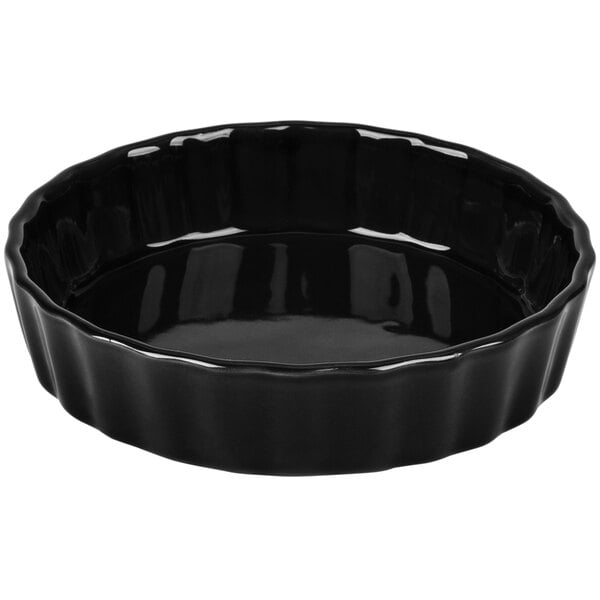 A black round fluted china quiche dish.