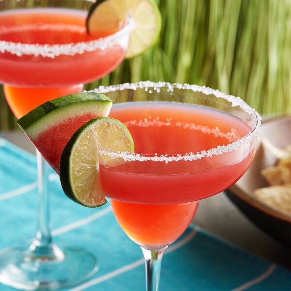 A DaVinci Gourmet watermelon and lime drink in a glass with a lime wedge.