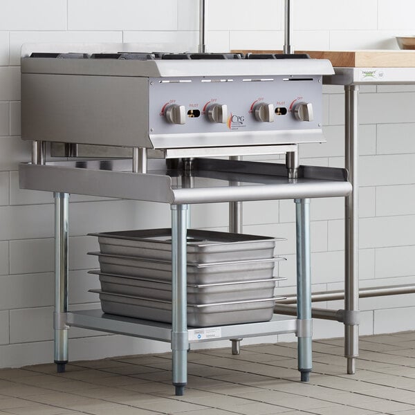 A Steelton stainless steel equipment stand with galvanized legs and an undershelf holding two pans.