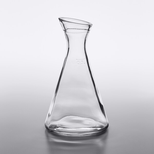 A Stolzle clear glass Pisa carafe on a table.